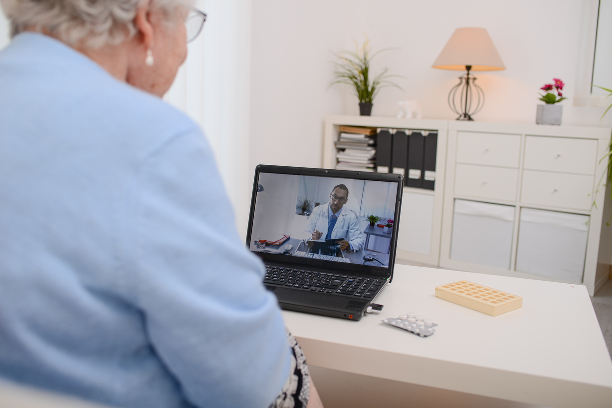 elderly senior woman, having a remote medical consultation with her doctor over internet computer telemedecine diagnostic